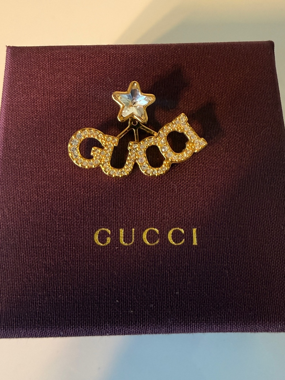 Gucci Gold-tone Crystal 'GUCCI' Logo Star earring with Clear Stone